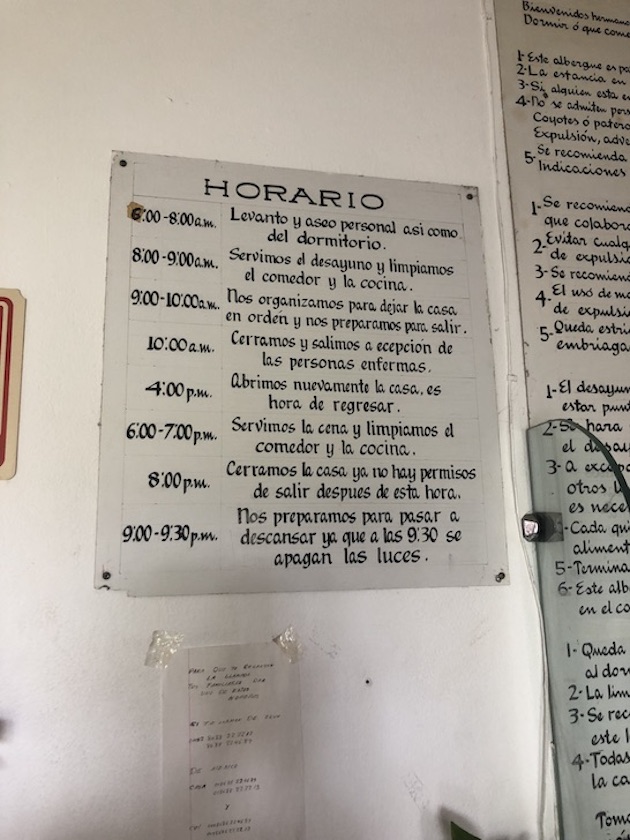 Sign on a wall that has the daily schedule written out